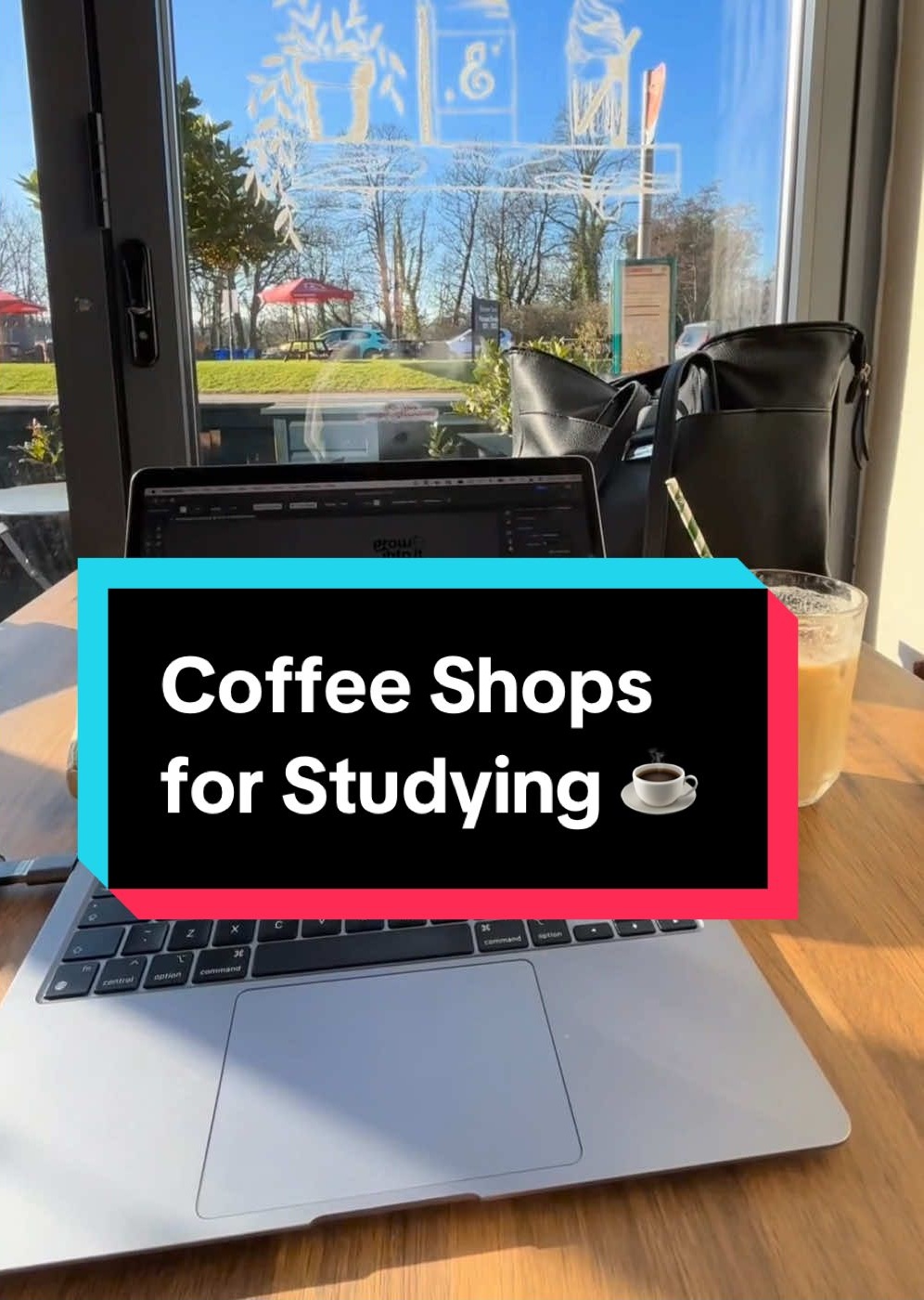 A point of view of an individual working from a laptop in front of a large window