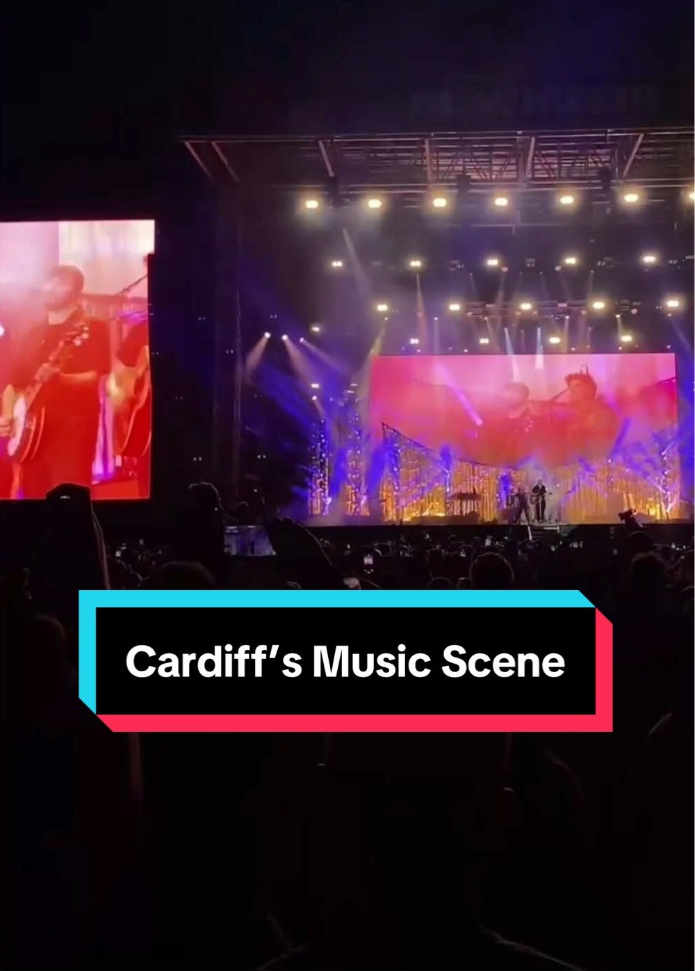 A band performs live music on a large stage