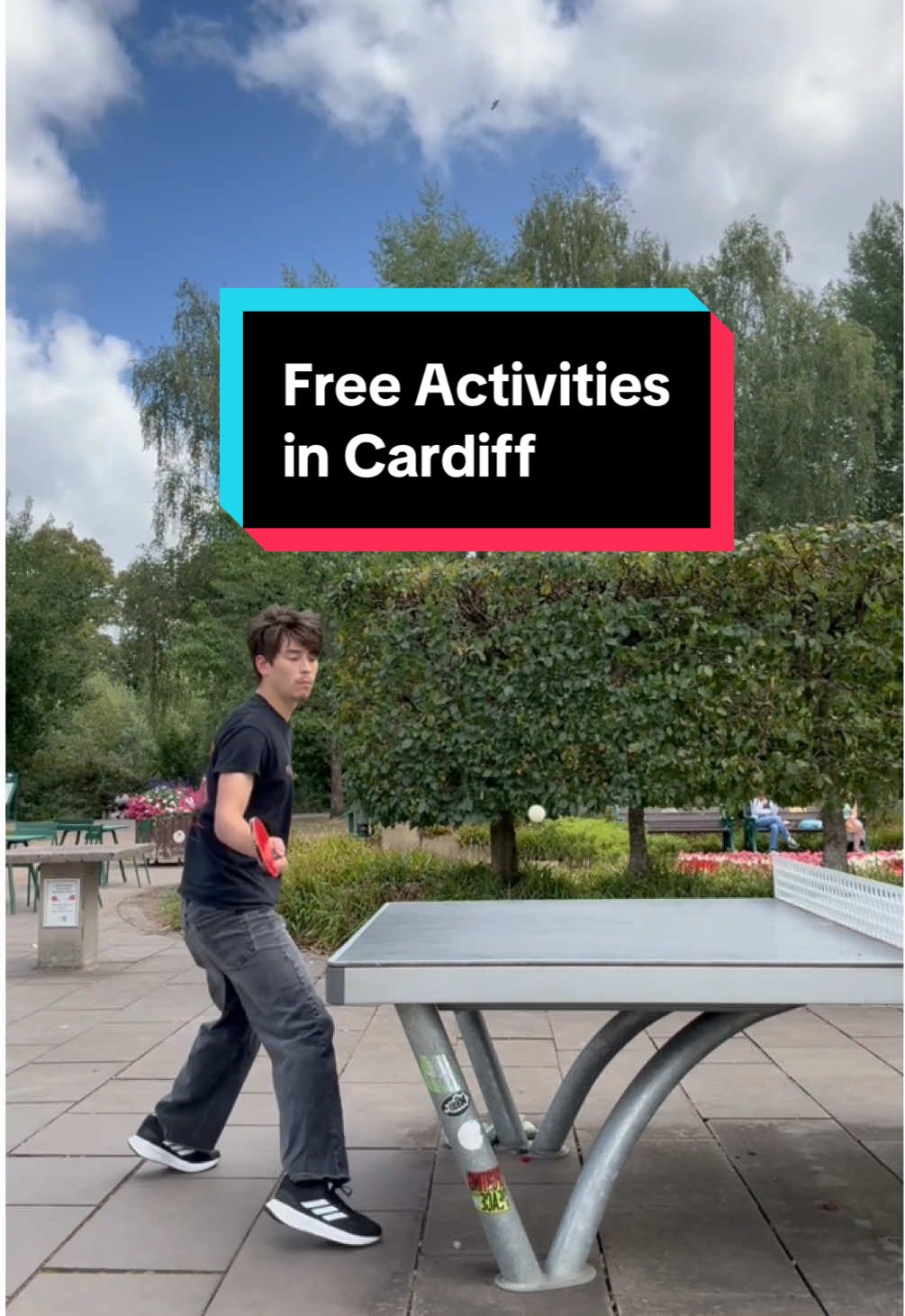 A young man reaches to hit a ping pong ball during a game of table tennis